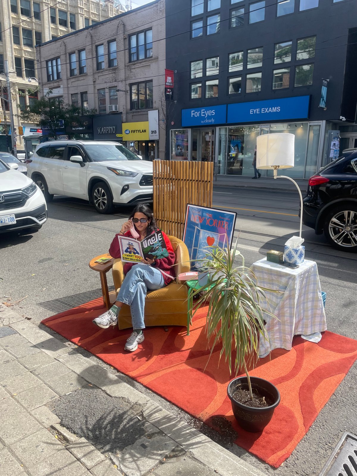 A visitor sitting in the armchair answering the phone